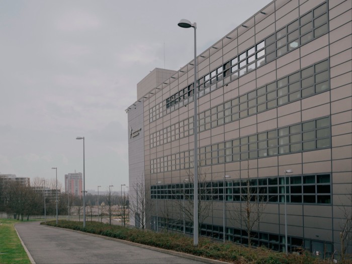 The side of a modern building with a lamp post in the foreground
