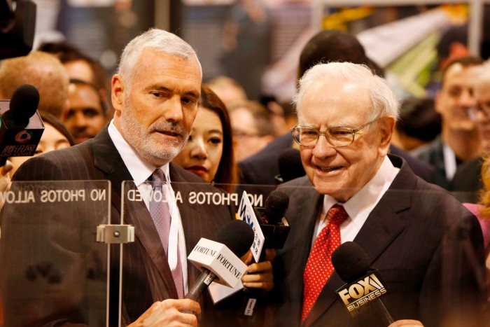 Warren Buffett, right, talks with Mark Donegan, CEO of Precision Castparts, at the Precision Castparts booth in exhibit hall during the Berkshire Hathaway Annual Shareholders Meeting