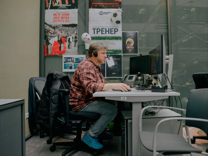 A man sitting at a desk looking at a computer screen