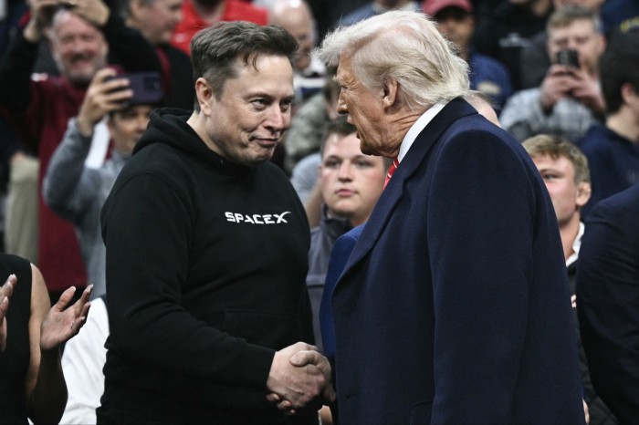 Elon Musk and Donald Trump shake hands