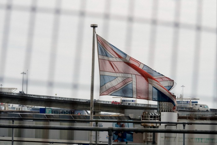 A flag of Britain flying in front of a Dover terminal