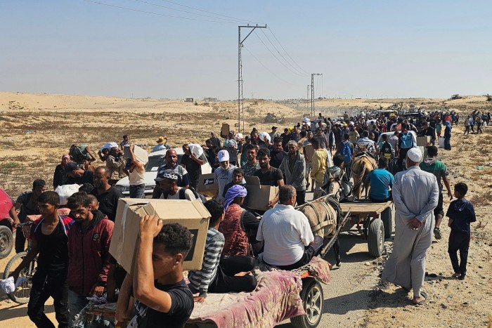 Displaced Palestinians walk along a road to receive humanitarian aid packages from a US-backed foundation in Rafah in the southern Gaza Strip on June 5